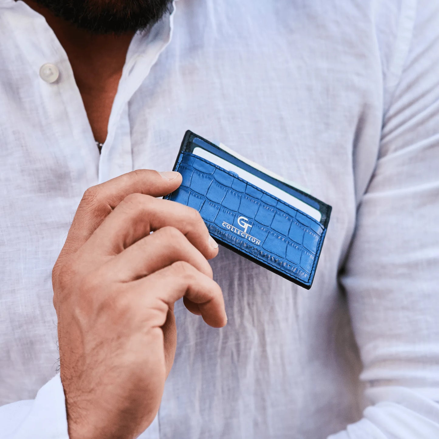 Man holding blue GT Collection leather card holder with multiple slots