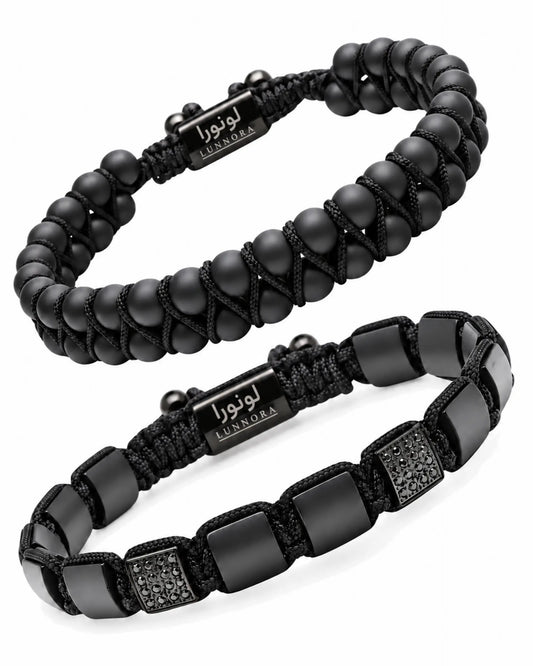 Two black beaded bracelets with woven logo tags and rectangular bead panels