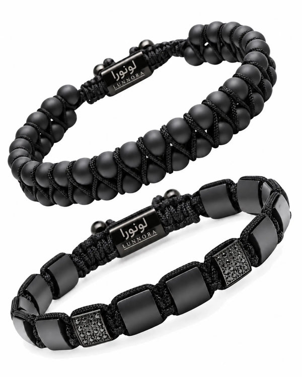 Two black beaded bracelets with woven logo tags and rectangular bead panels
