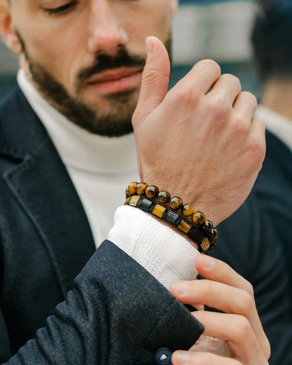 Tiger eye beaded bracelets worn on wrist with black leather and bead details