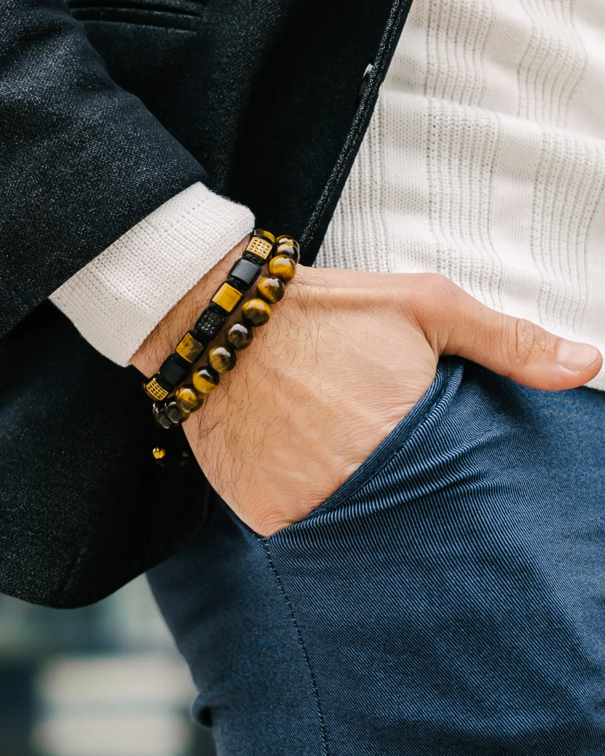 Tiger eye beaded bracelet stacked on wrist with black bands and tiger eye beads