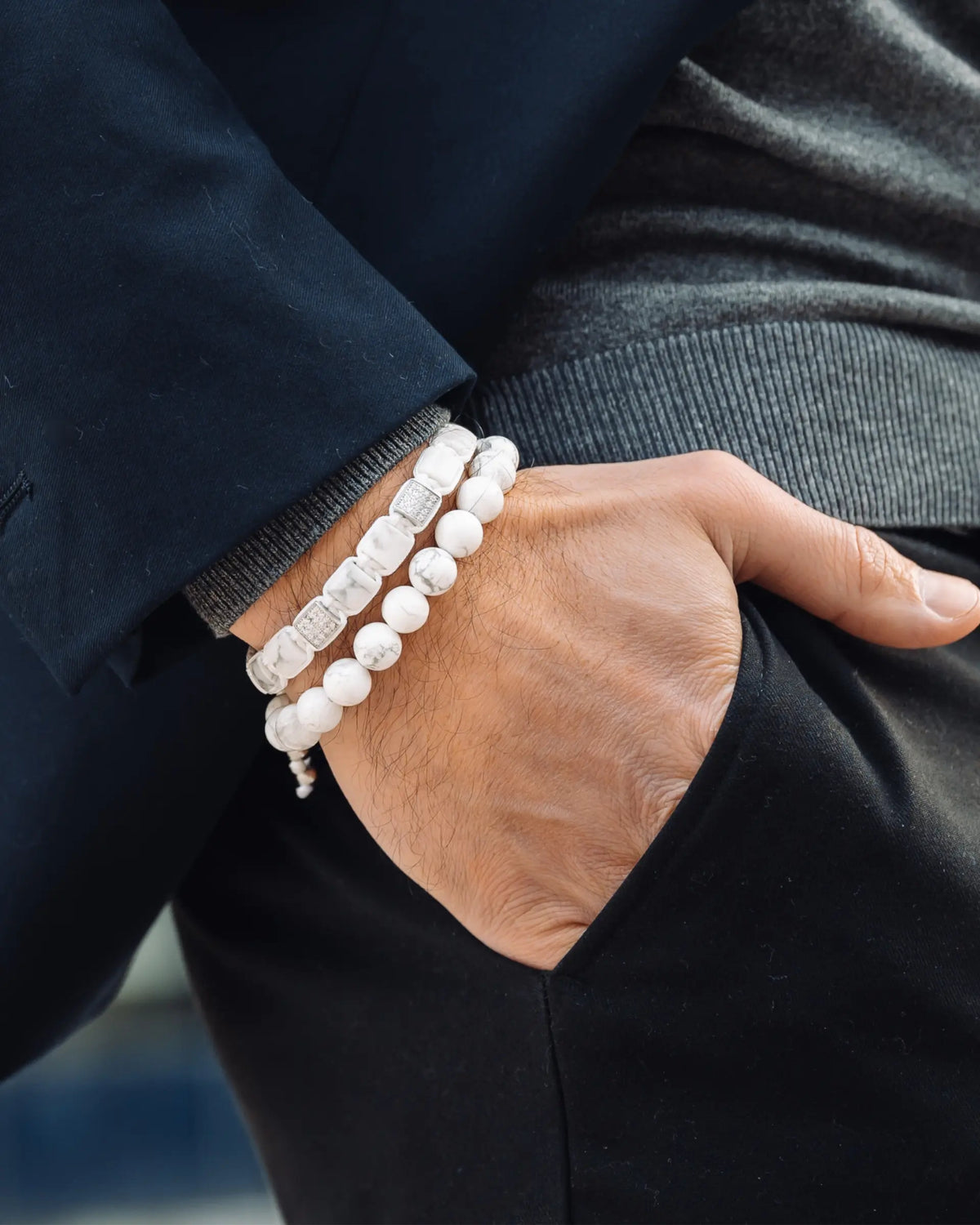 Howlite bead bracelets on wrist, white round beads with silver-tone ball spacers