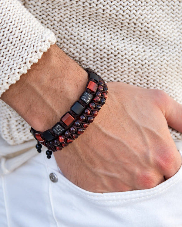 Close-up: stacked bead and cuff bracelet in black and burgundy on wrist