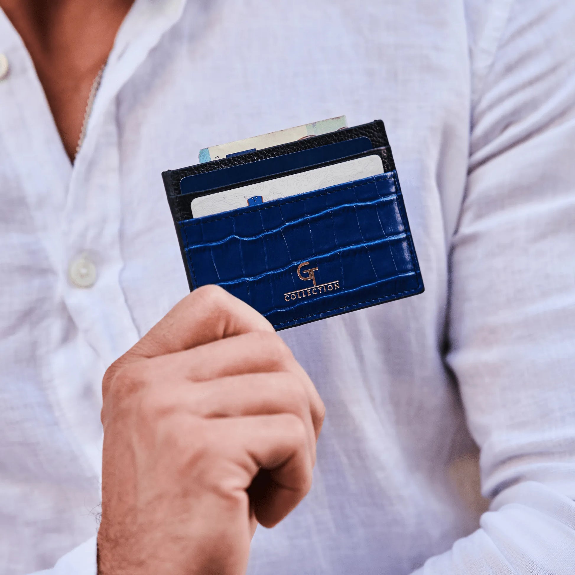 Man holding blue GT Collection leather card holder with multiple slots