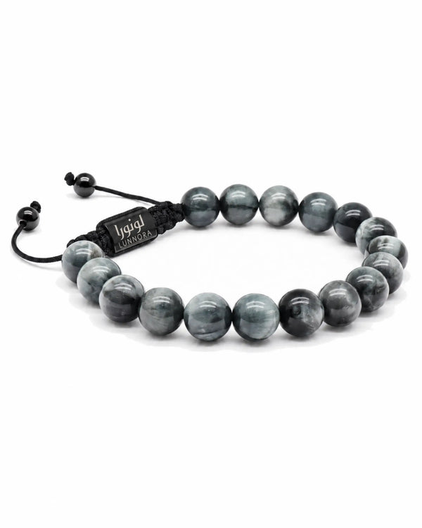 Single-row beaded bracelet with gray round stones and black adjustable cord with tag