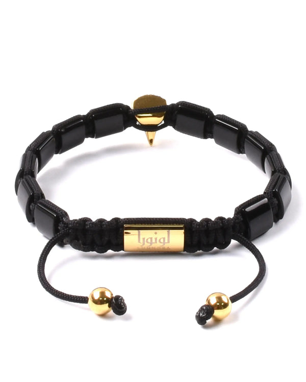 Black bead bracelet with gold label bead and dangling cord with gold bead caps
