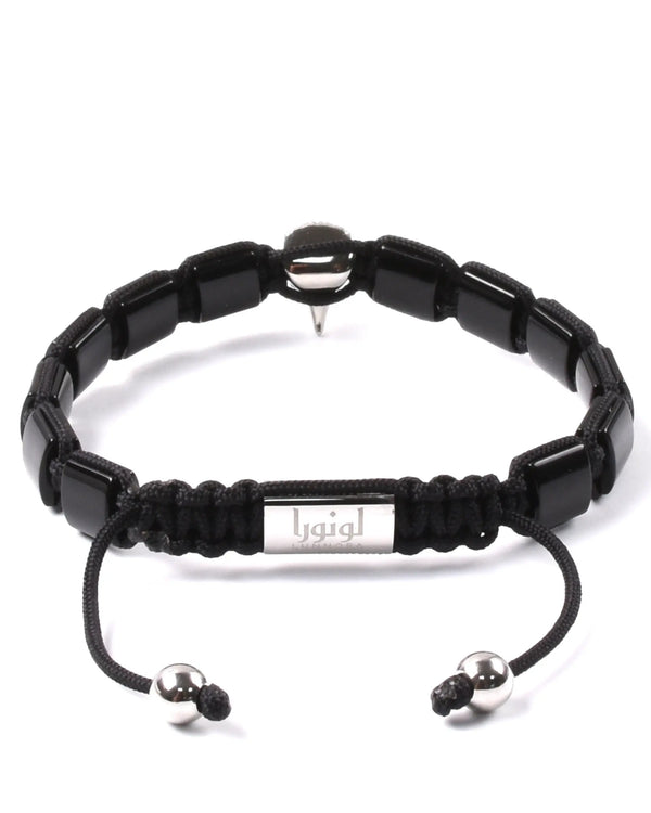 Black beaded bracelet with silver clasp bar and dangling cord ends