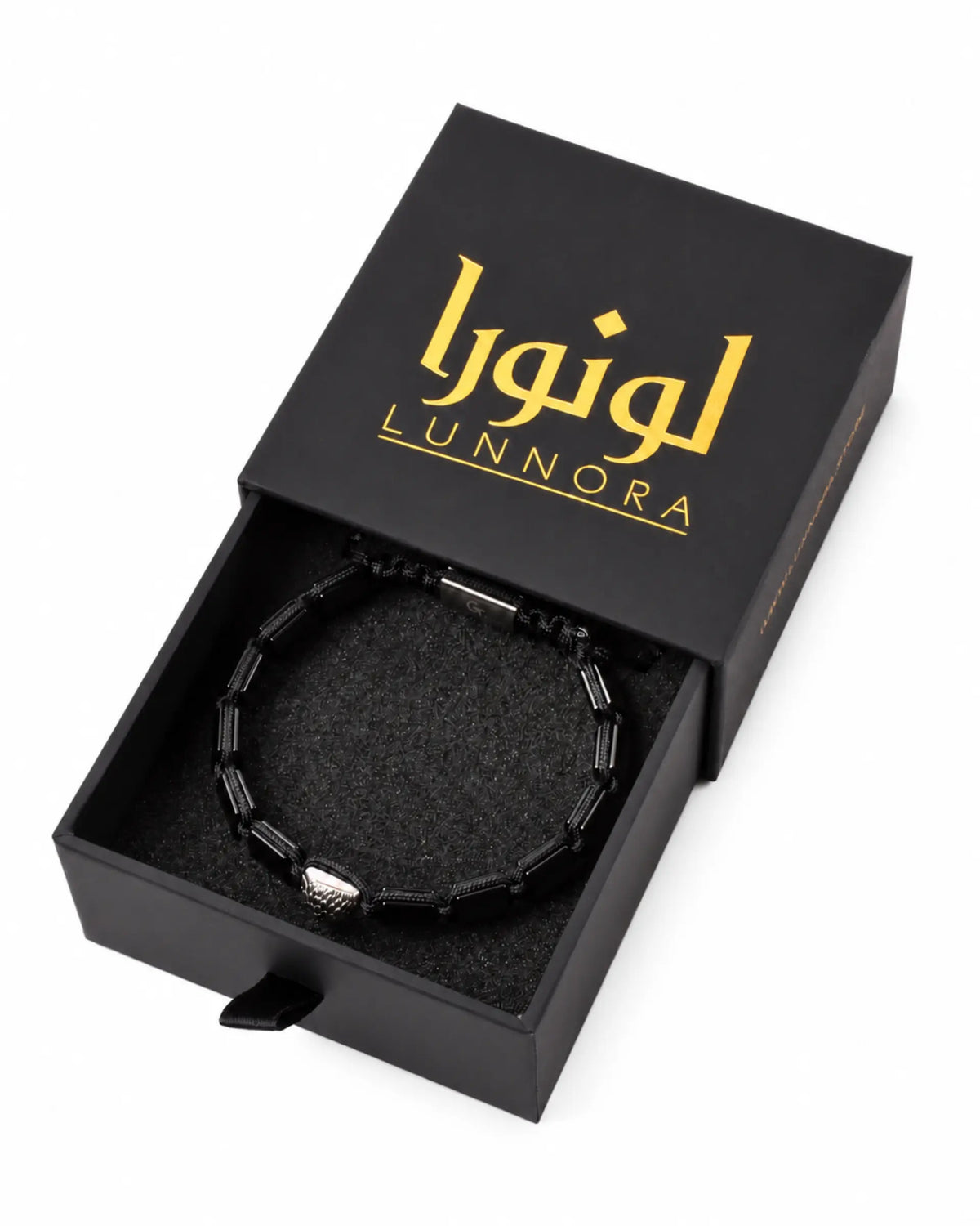 Black bracelet in open gift box with black lining and silver bead accents
