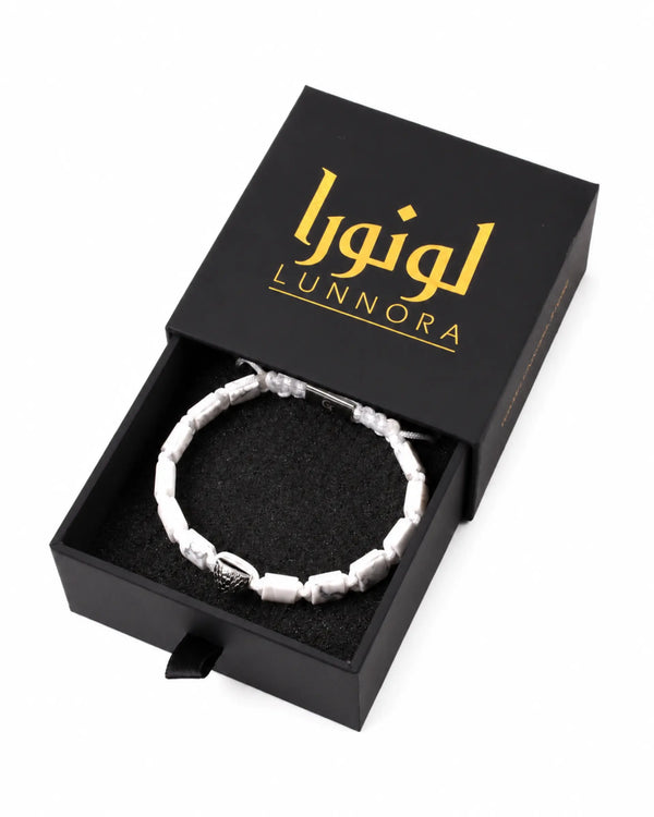 Howlite beaded bracelet displayed in black gift box with gold brand logo
