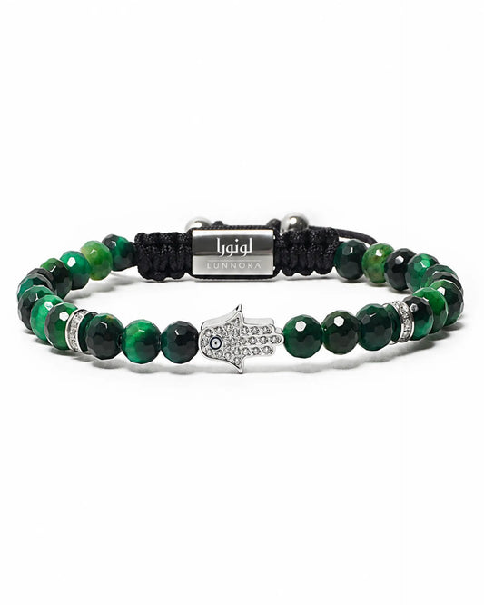 Green beaded bracelet with black cord, silver hamsa charm, and metal center plate