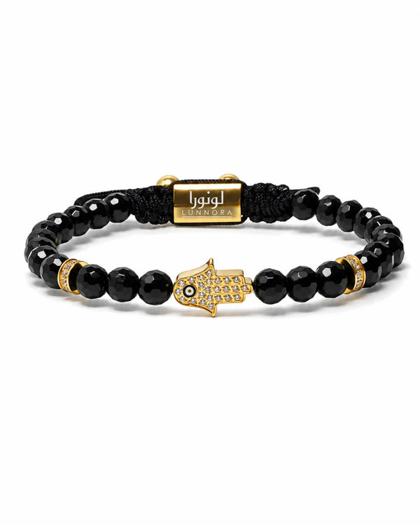 Black onyx bead hamsa bracelet with gold clasp and central hamsa charm, black cord