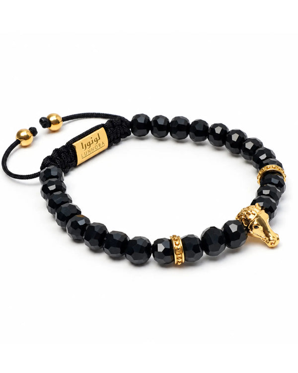 Black onyx beaded bracelet with gold-toned horse charm, adjustable cord and beads