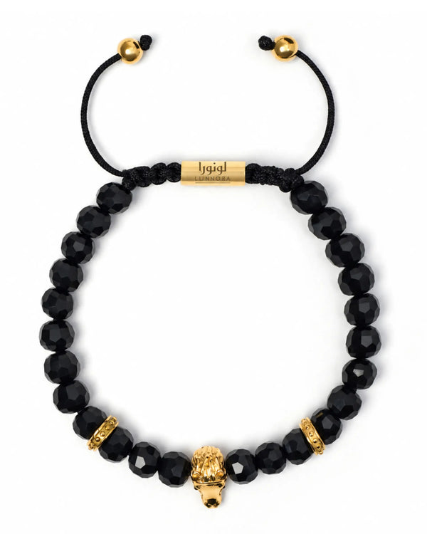 Black onyx beaded bracelet with gold-toned horse head charm and stacked bead accents