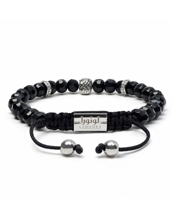 Black beaded bracelet with braided cord, silver-tone horse charm, and engraved tag