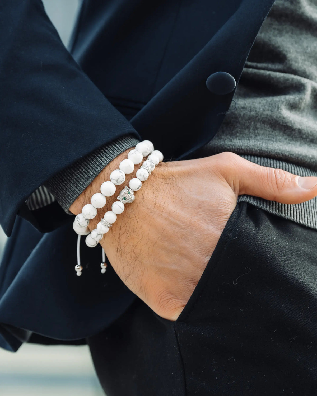 Men’s wrist wearing white howlite bead bracelet stack with elephant charm and silver spacers
