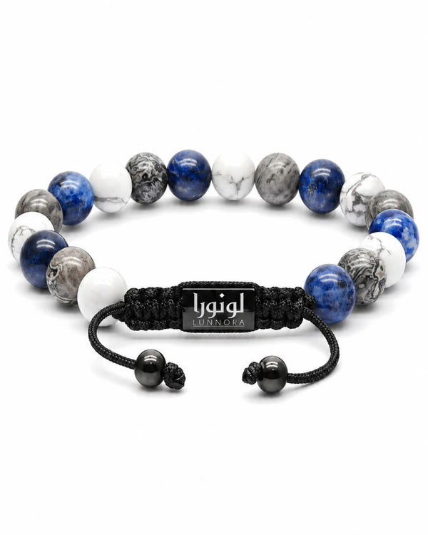 Single-row gemstone bracelet with blue and white beads and black cord with logo tag