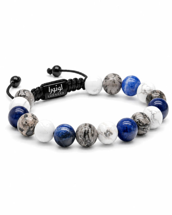 Blue and white stone bracelet with black cord band and rectangular logo plate
