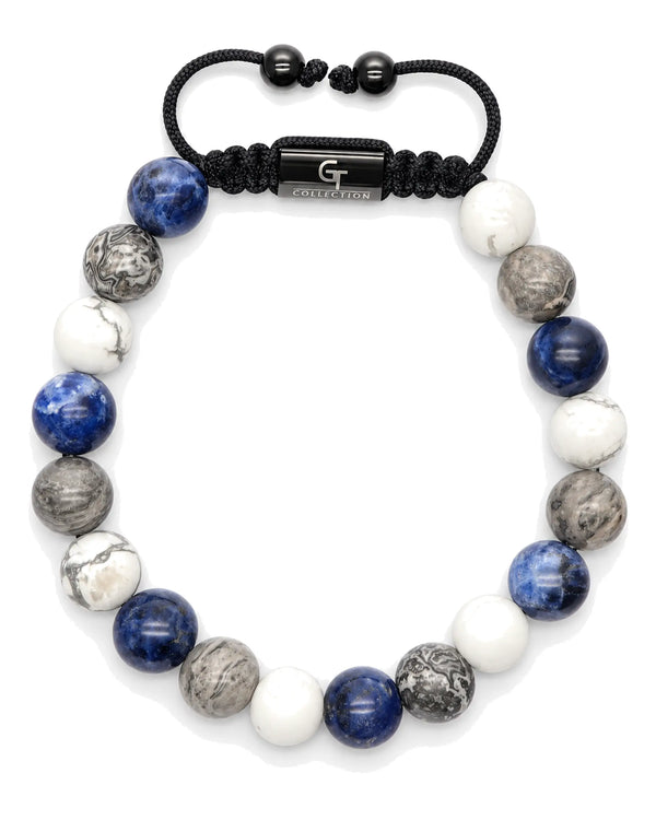 Beaded bracelet with white, blue, gray and black beads plus center bar charm