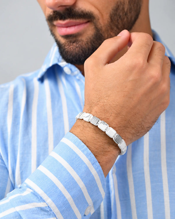 White howlite bead bracelet with gray segments, on man’s wrist