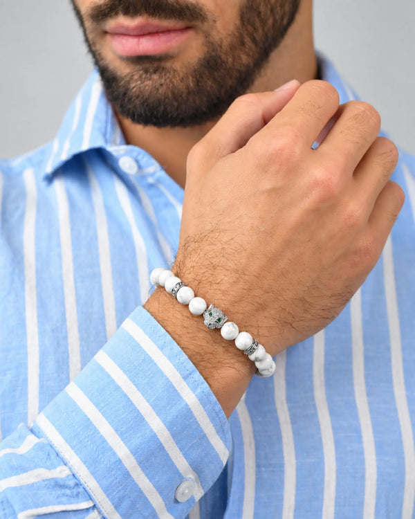 White howlite bead bracelet with silver-tone spacers, worn on wrist