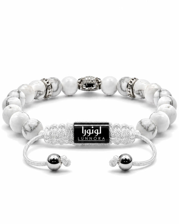 White howlite bead bracelet with black logo tag and silver-tone centerpiece