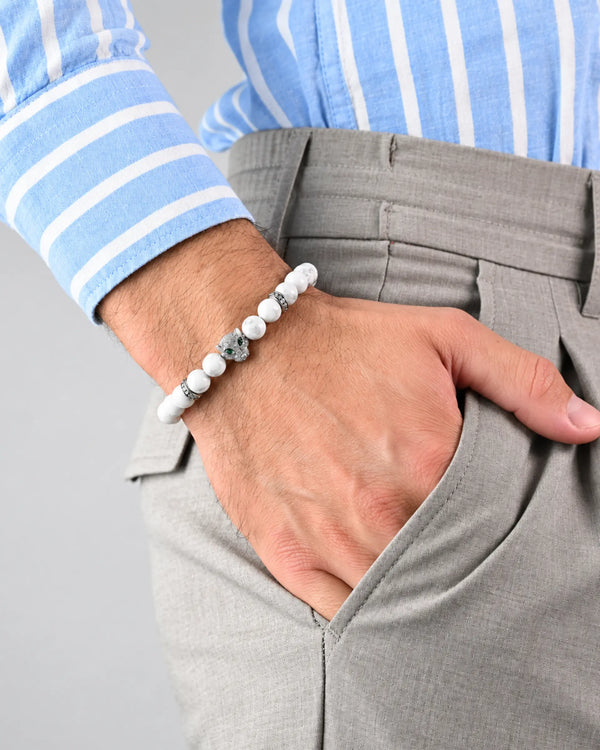 White howlite bead bracelet with silver-tone accents, worn with light trousers