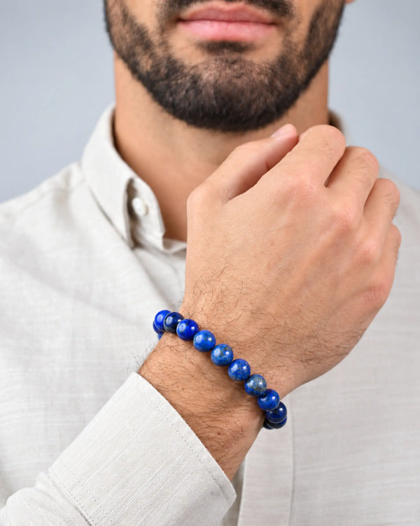 Lapis lazuli bead bracelet with silver clasp, worn on forearm