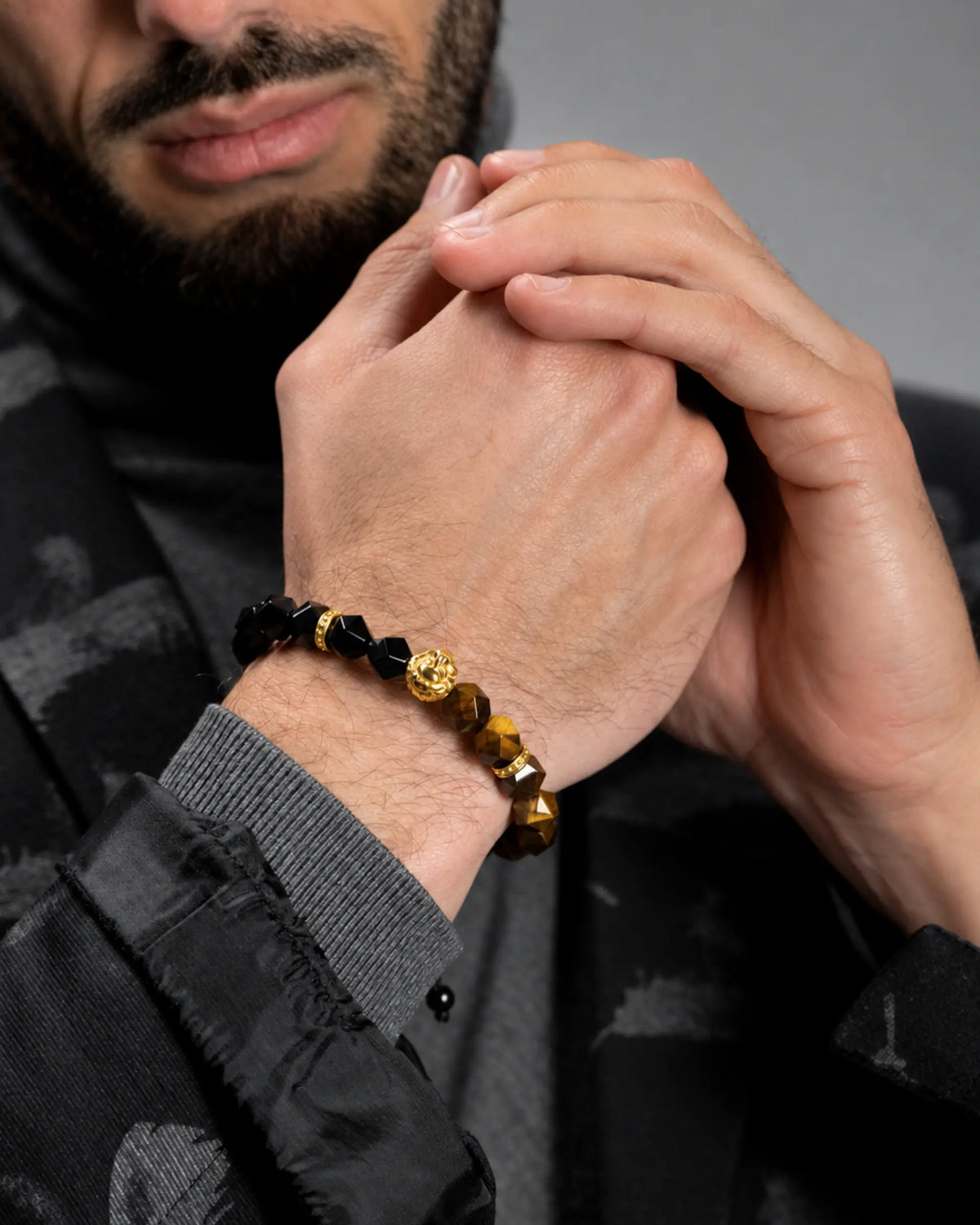 Tiger eye and black onyx beaded bracelet with gold lion head charm, dark clasp