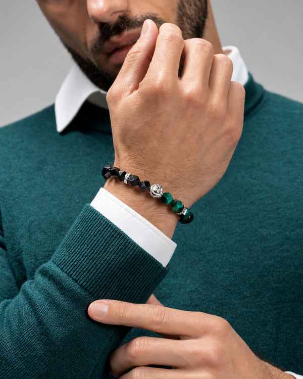 Lion head bead bracelet on wrist, black faceted onyx and green tiger-eye bead segments