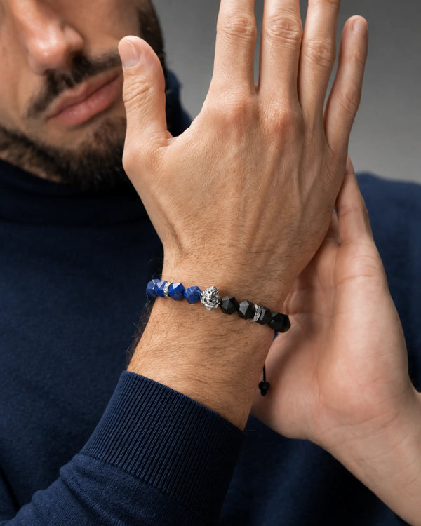 Bracelet worn on wrist: blue lapis lazuli beads with black onyx cubes and silver details