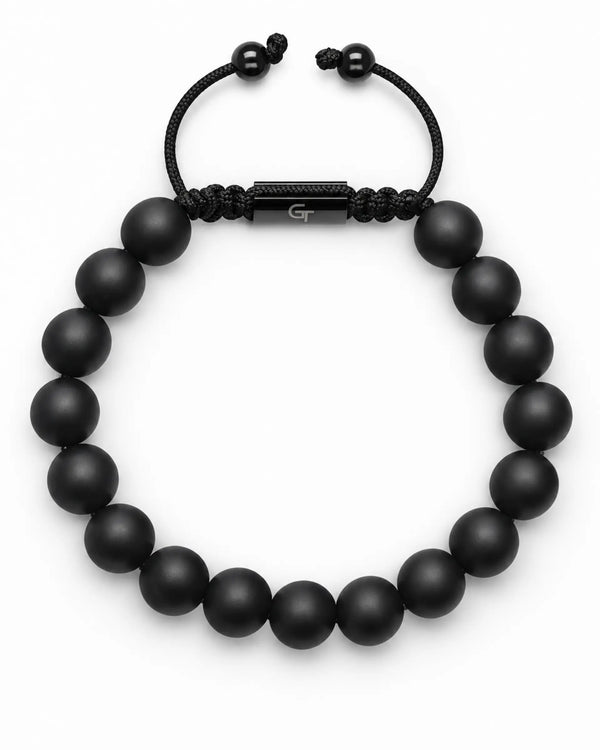 Black beaded bracelet with engraved metal bar center and braided elastic cord