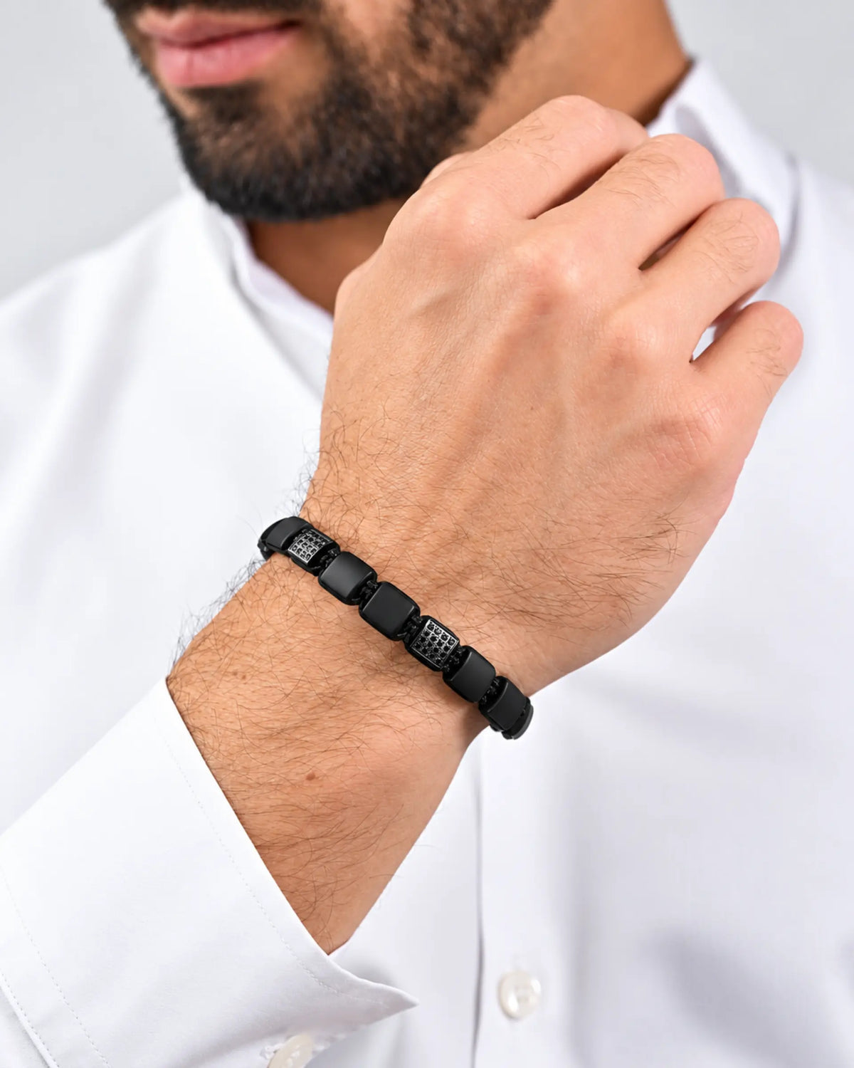 Black onyx flat bead bracelet with black cord and adjustable clasp