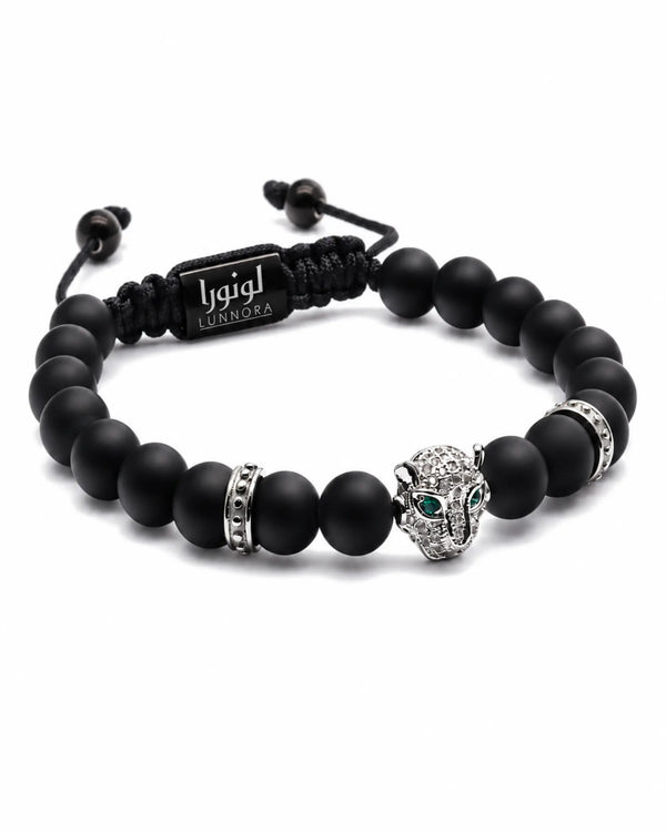 Two black beaded bracelets with silver ring accents and green cat head charm