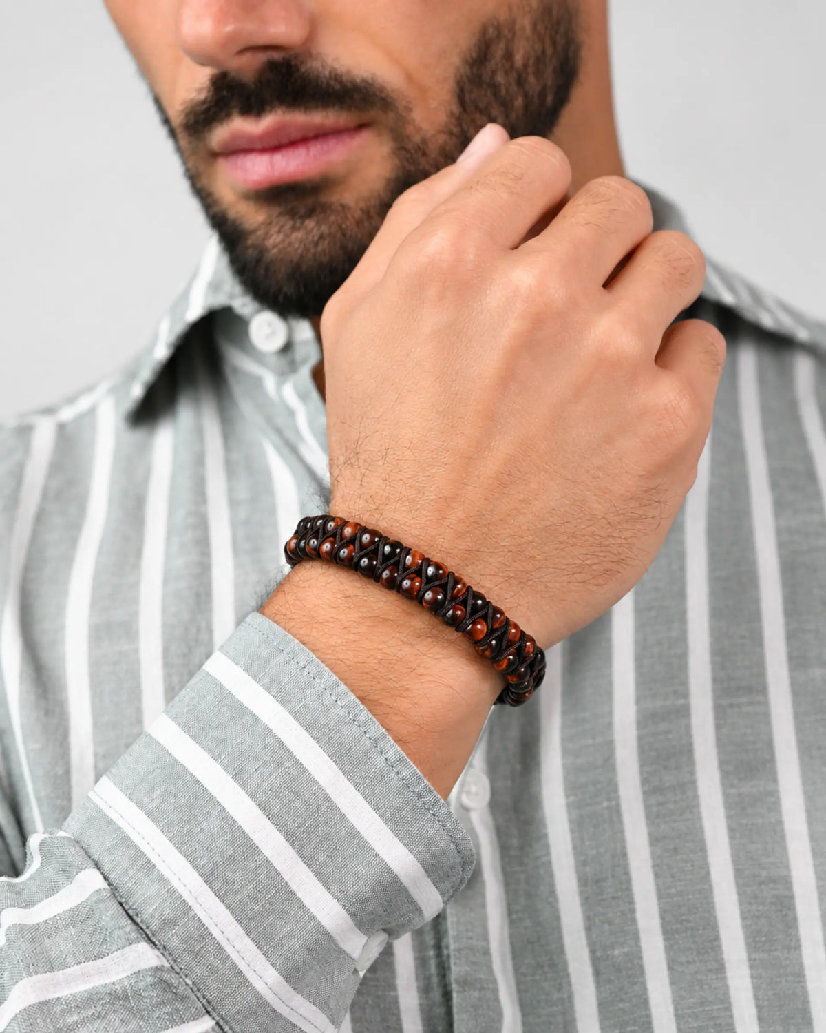 Double-row beaded bracelet in red and dark brown with elastic cord on wrist