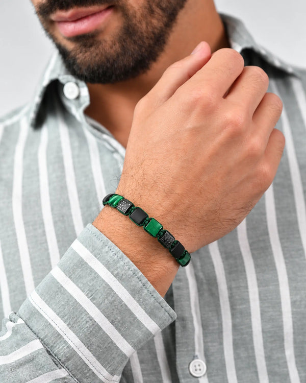 Green tiger-eye and black onyx flat bead bracelet on wrist with clasp