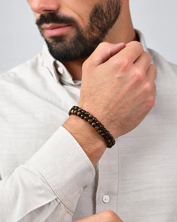 Double-row tiger eye beaded bracelet with black accents on a man's wrist