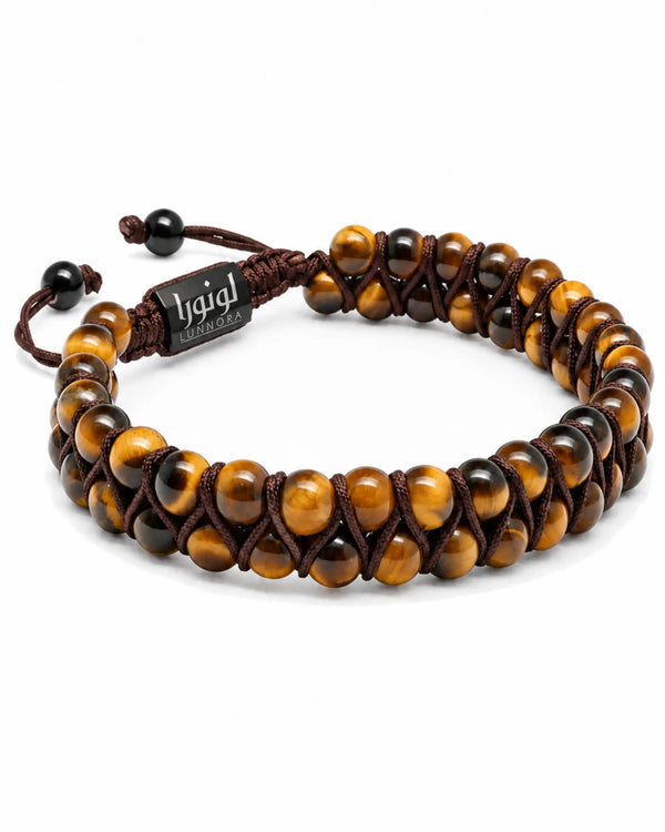 Tiger-eye bead bracelet with brown braided ties and central black logo tag, side view